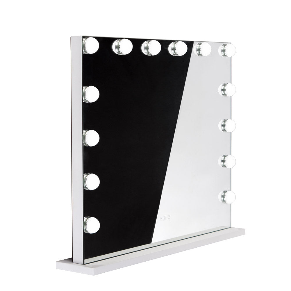 LED illuminated Hollywood mirror by Beauty System, 80x65cm with bright lighting, reflecting a modern bathroom vanity.