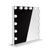LED illuminated Hollywood mirror by Beauty System, 80x65cm with bright lighting, reflecting a modern bathroom vanity.