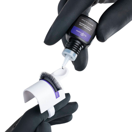 PhiLashes Diamond Lash Clear Adhesive — adhesive being dispensed into a ring cup