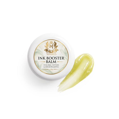 Skin Monarch Ink Booster Balm 30ml, lid beside a glossy yellow balm smear